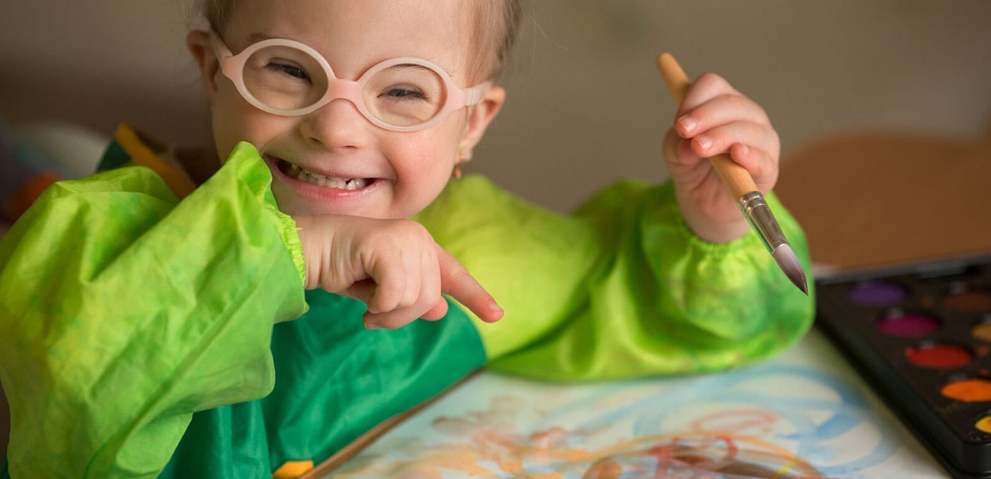 Young girl with paintbrush painting