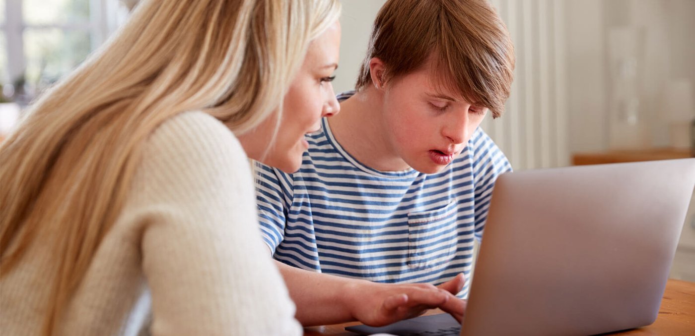 Support work helping young person with a computer