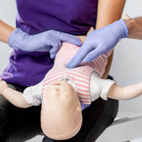 Healthcare worker training on a dummy baby